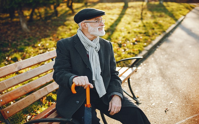Handsome grandfather in a autumn park. Old man